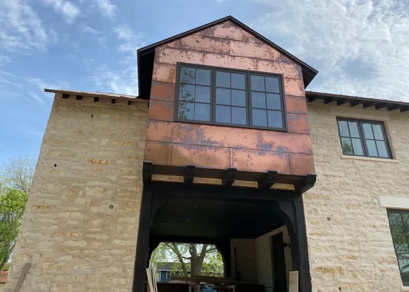 Copper metal panel facade on a stone building for Skylight Installation in Bellaire